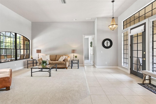 6710 Merryvale Ln, Port Orange, FL 32128 - living area featuring a high ceiling, light tile patterned flooring, and a chandelier
