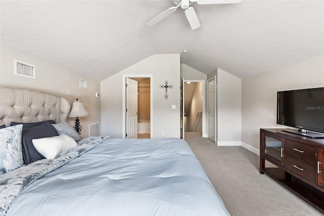 6710 Merryvale Ln, Port Orange, FL 32128 - bedroom with light carpet, lofted ceiling, a textured ceiling, connected bathroom, and a ceiling fan