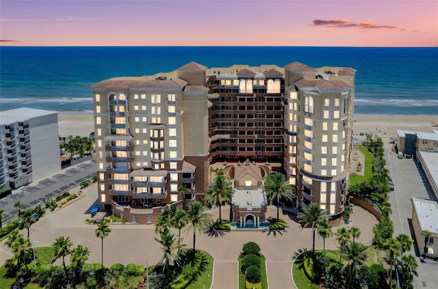 2515 S Atlantic Ave Unit 507, Daytona Beach, FL 32118 - property at dusk featuring view of water and beach and a view of apartment building / complex