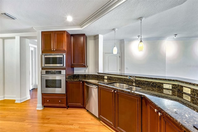2515 S Atlantic Ave Unit 507, Daytona Beach, FL 32118 - kitchen with stainless steel appliances, a textured ceiling, light wood finished floors, dark stone countertops, and decorative light fixtures