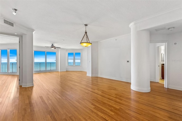 2515 S Atlantic Ave Unit 507, Daytona Beach, FL 32118 - empty room with light wood-style floors, a textured ceiling, a ceiling fan, crown molding, and a smoke detector