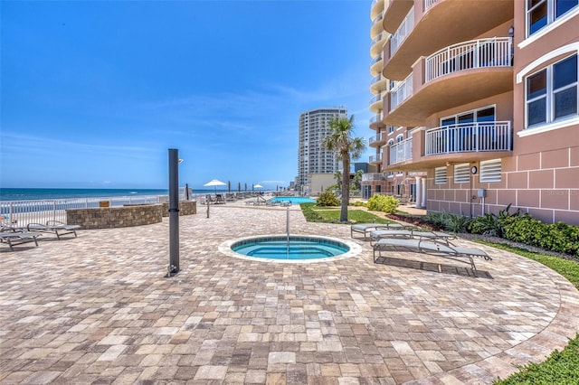 2515 S Atlantic Ave Unit 507, Daytona Beach, FL 32118 - view of pool with a hot tub, a water view, and a patio