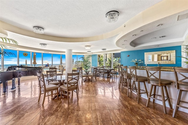 2515 S Atlantic Ave Unit 507, Daytona Beach, FL 32118 - tiled dining area with a textured ceiling and a tray ceiling