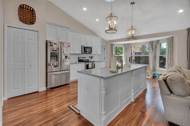 1522 E Silver Hammock, Deland, FL 32720 - kitchen featuring stainless steel appliances, lofted ceiling, a chandelier, white cabinets, and backsplash