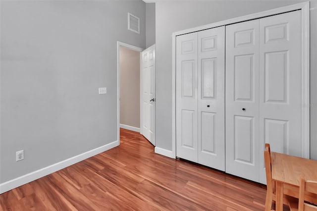1522 E Silver Hammock, Deland, FL 32720 - unfurnished bedroom with light wood-type flooring and a closet
