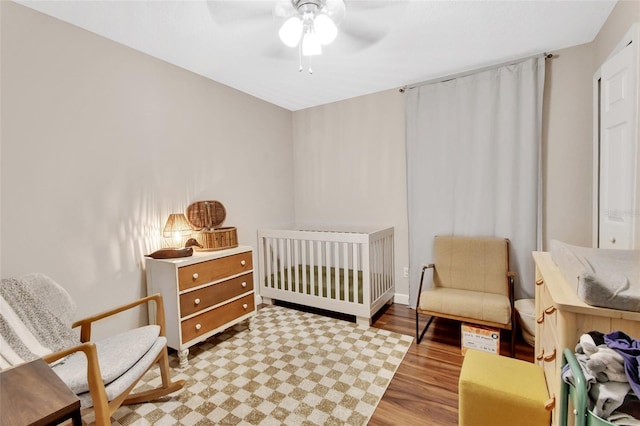 1522 E Silver Hammock, Deland, FL 32720 - bedroom with wood finished floors, ceiling fan, and a crib