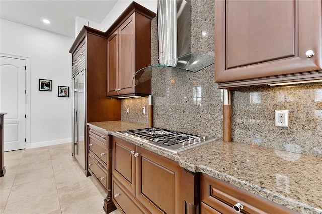 12812 Jacob Grace Ct, Windermere, FL 34786 - kitchen featuring stainless steel appliances, wall chimney exhaust hood, tasteful backsplash, light tile patterned floors, and recessed lighting