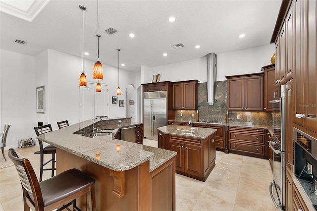 12812 Jacob Grace Ct, Windermere, FL 34786 - kitchen with stainless steel appliances, a spacious island, decorative backsplash, a kitchen bar, and recessed lighting