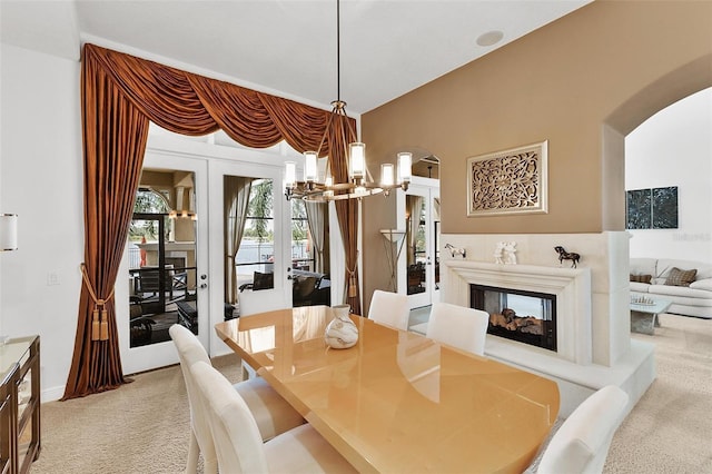 12812 Jacob Grace Ct, Windermere, FL 34786 - dining area featuring arched walkways, carpet floors, a chandelier, and french doors