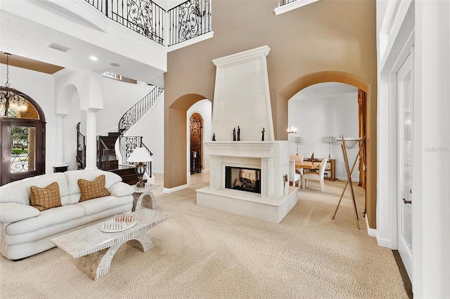 12812 Jacob Grace Ct, Windermere, FL 34786 - living area featuring a high ceiling, arched walkways, and light colored carpet