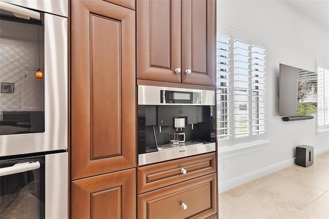 12812 Jacob Grace Ct, Windermere, FL 34786 - kitchen featuring stainless steel double oven, light tile patterned flooring, and brown cabinetry