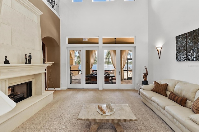 12812 Jacob Grace Ct, Windermere, FL 34786 - living room with a high ceiling, carpet flooring, a fireplace, healthy amount of natural light, and french doors