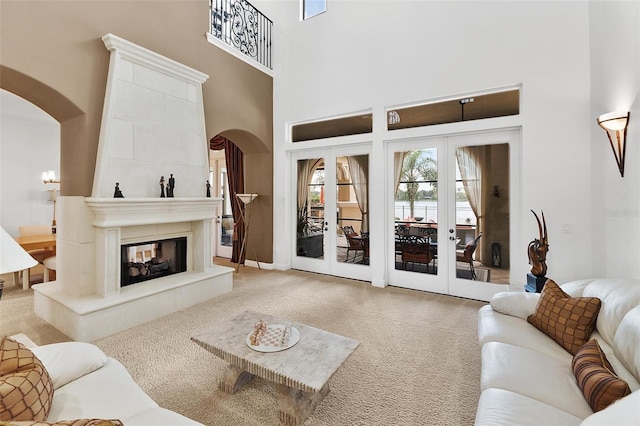 12812 Jacob Grace Ct, Windermere, FL 34786 - living area with arched walkways, carpet, a towering ceiling, and a fireplace
