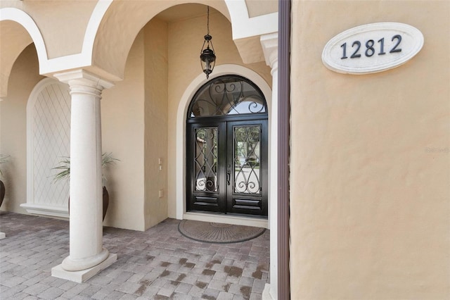 12812 Jacob Grace Ct, Windermere, FL 34786 - view of exterior entry with french doors and stucco siding