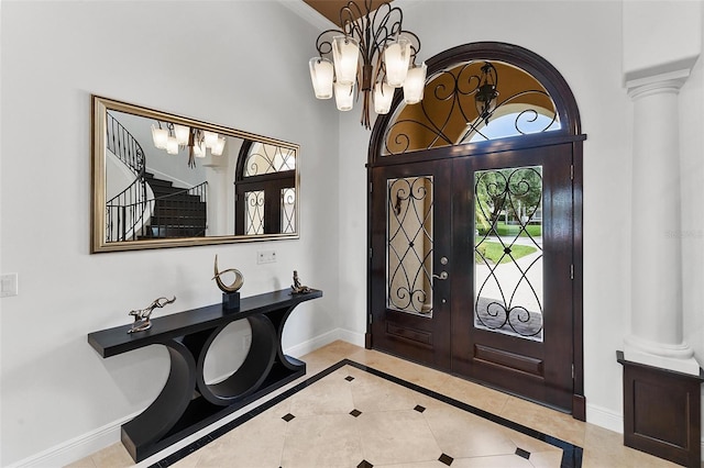 12812 Jacob Grace Ct, Windermere, FL 34786 - foyer entrance with a chandelier, ornate columns, and light tile patterned floors