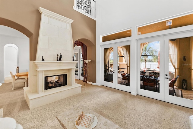12812 Jacob Grace Ct, Windermere, FL 34786 - carpeted living area featuring french doors, arched walkways, and a multi sided fireplace