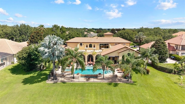 12812 Jacob Grace Ct, Windermere, FL 34786 - back of property featuring a tiled roof, an outdoor pool, a yard, and stucco siding