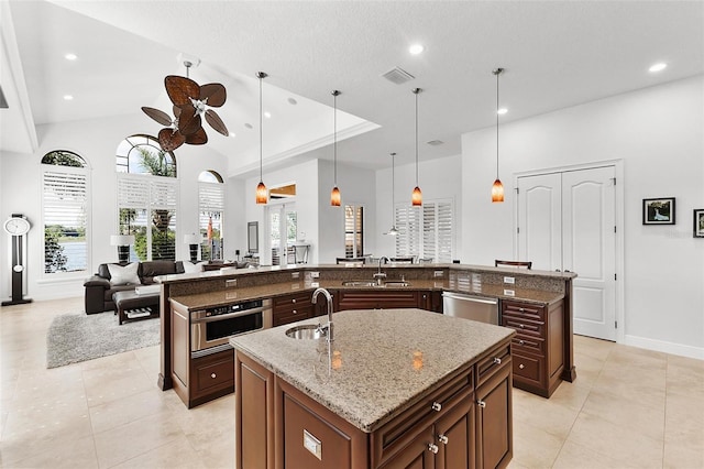 12812 Jacob Grace Ct, Windermere, FL 34786 - kitchen with a large island with sink, a ceiling fan, light tile patterned floors, stainless steel appliances, and recessed lighting