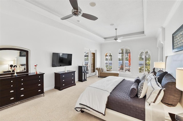12812 Jacob Grace Ct, Windermere, FL 34786 - bedroom with light colored carpet, a tray ceiling, and a ceiling fan