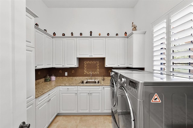 12812 Jacob Grace Ct, Windermere, FL 34786 - laundry room with washing machine and dryer, cabinet space, and light tile patterned floors