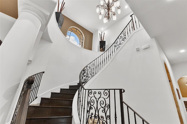 12812 Jacob Grace Ct, Windermere, FL 34786 - stairs featuring a towering ceiling, a chandelier, arched walkways, and recessed lighting