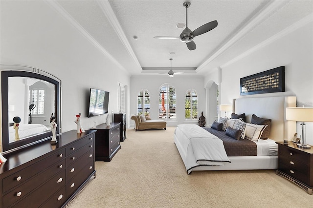 12812 Jacob Grace Ct, Windermere, FL 34786 - bedroom featuring arched walkways, a tray ceiling, light colored carpet, multiple windows, and ornamental molding