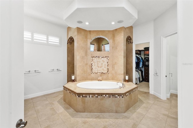 12812 Jacob Grace Ct, Windermere, FL 34786 - bathroom featuring a garden tub, a walk in closet, tile patterned flooring, and recessed lighting