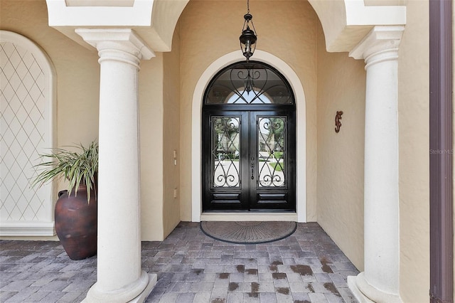 12812 Jacob Grace Ct, Windermere, FL 34786 - view of exterior entry featuring french doors and stucco siding