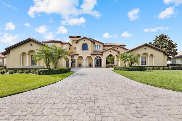 12812 Jacob Grace Ct, Windermere, FL 34786 - mediterranean / spanish home featuring curved driveway, stucco siding, a tiled roof, and a front yard