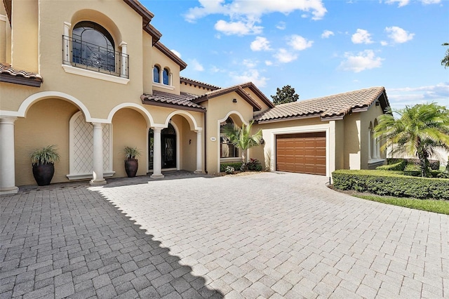 12812 Jacob Grace Ct, Windermere, FL 34786 - mediterranean / spanish-style house with a balcony, decorative driveway, a garage, and stucco siding