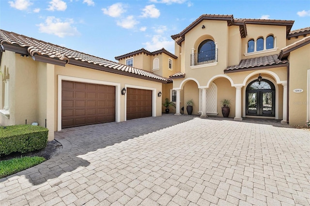12812 Jacob Grace Ct, Windermere, FL 34786 - mediterranean / spanish-style home featuring french doors, decorative driveway, a tiled roof, and stucco siding