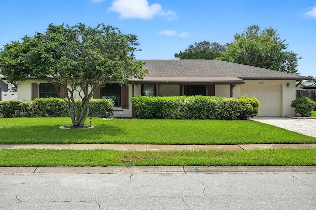 2931 Lantern Dr, South Daytona, FL 32119 - view of front of house with a garage, a front yard, driveway, stucco siding, and a shingled roof