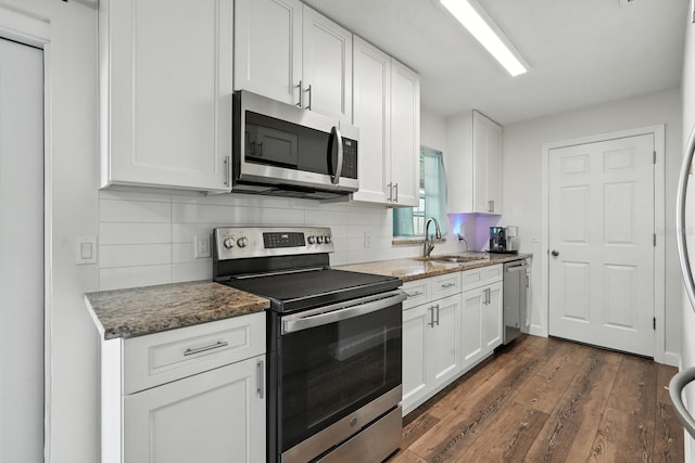2931 Lantern Dr, South Daytona, FL 32119 - kitchen featuring stainless steel appliances, dark wood-style floors, tasteful backsplash, white cabinetry, and stone counters