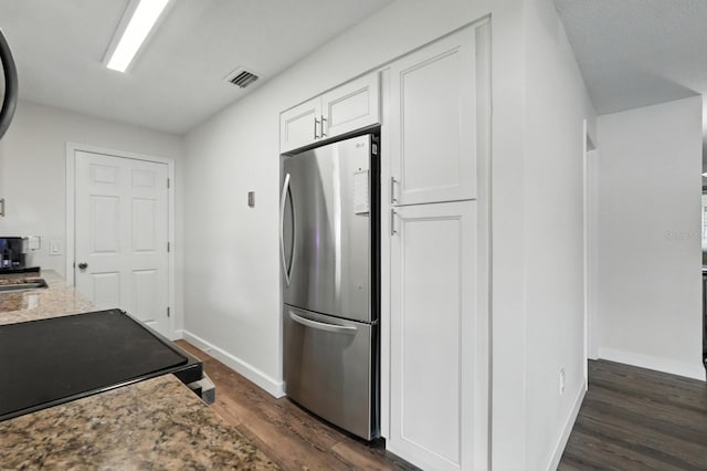 2931 Lantern Dr, South Daytona, FL 32119 - kitchen with freestanding refrigerator, dark wood finished floors, white cabinetry, electric range, and light stone countertops