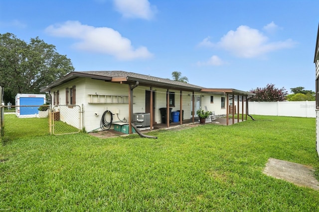 2931 Lantern Dr, South Daytona, FL 32119 - back of house featuring concrete block siding, a fenced backyard, a patio, and a shingled roof