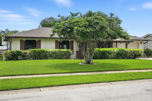 2931 Lantern Dr, South Daytona, FL 32119 - view of front of house featuring stucco siding, roof with shingles, a front yard, and an attached garage