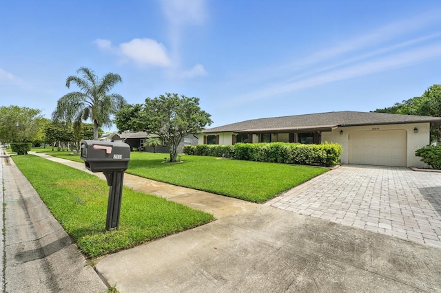 2931 Lantern Dr, South Daytona, FL 32119 - single story home with decorative driveway, a garage, a front lawn, and stucco siding