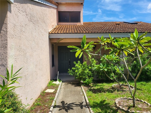 5915 Crystal View Dr, Orlando, FL 32819 - property entrance with a tile roof and stucco siding
