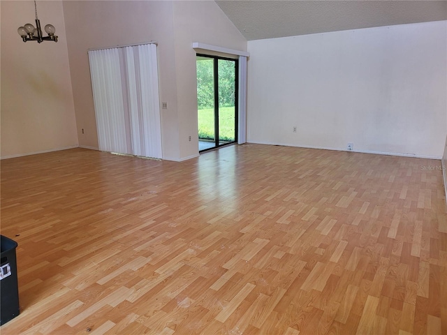 5915 Crystal View Dr, Orlando, FL 32819 - unfurnished room with high vaulted ceiling, a chandelier, and light wood finished floors