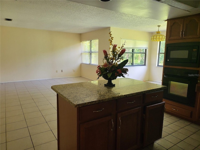 5915 Crystal View Dr, Orlando, FL 32819 - kitchen with black appliances, light tile patterned floors, a center island, a textured ceiling, and pendant lighting