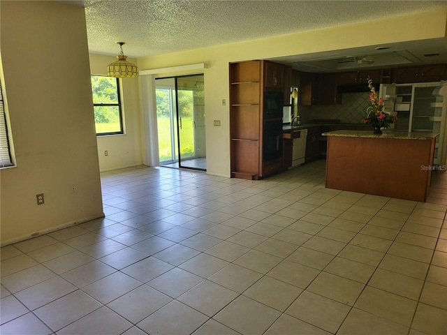 5915 Crystal View Dr, Orlando, FL 32819 - kitchen featuring white dishwasher, a textured ceiling, open shelves, light tile patterned floors, and pendant lighting