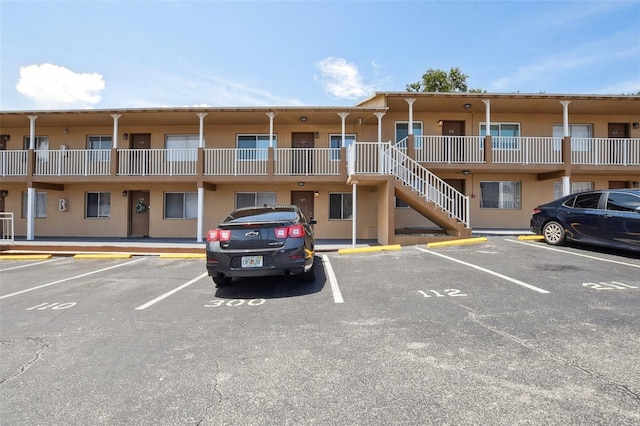 415 N Halifax Ave Unit 109, Daytona Beach, FL 32118 - view of building exterior with uncovered parking and stairway
