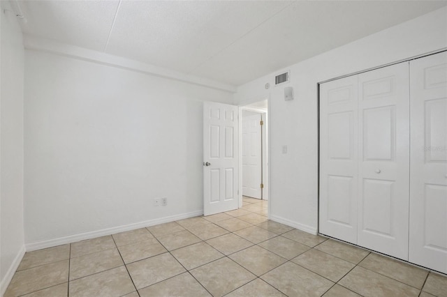 415 N Halifax Ave Unit 109, Daytona Beach, FL 32118 - unfurnished bedroom with light tile patterned floors and a closet