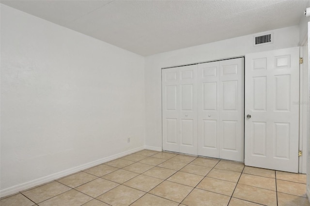 415 N Halifax Ave Unit 109, Daytona Beach, FL 32118 - unfurnished bedroom featuring light tile patterned floors and a closet