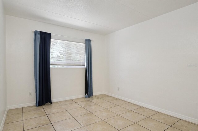 415 N Halifax Ave Unit 109, Daytona Beach, FL 32118 - unfurnished room with light tile patterned flooring and baseboards