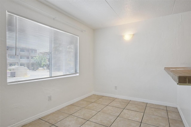 415 N Halifax Ave Unit 109, Daytona Beach, FL 32118 - empty room featuring light tile patterned floors and a textured ceiling