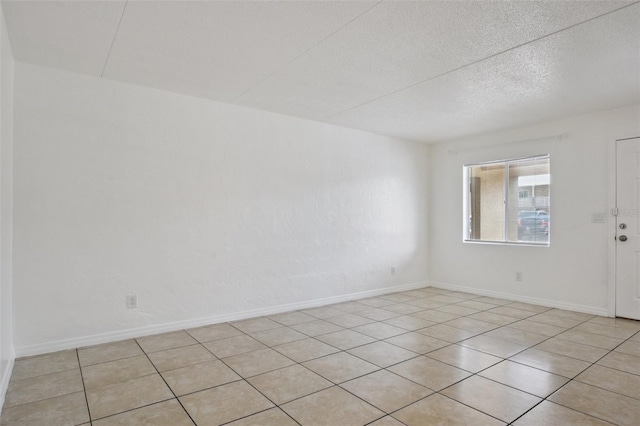 415 N Halifax Ave Unit 109, Daytona Beach, FL 32118 - unfurnished room featuring light tile patterned floors and a textured ceiling