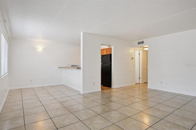 415 N Halifax Ave Unit 109, Daytona Beach, FL 32118 - empty room with light tile patterned flooring and a textured ceiling
