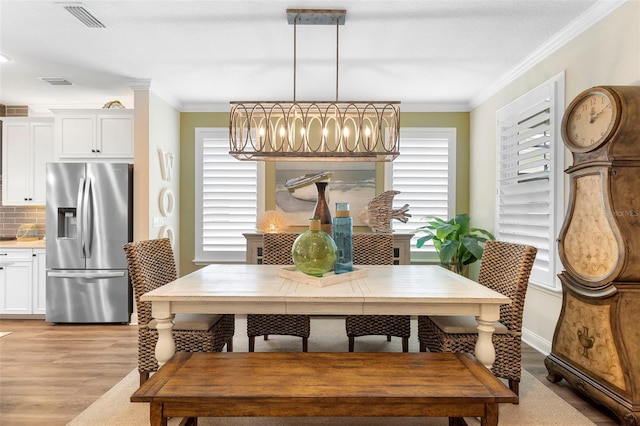 249 Kellet Way, Saint Johns, FL 32259 - dining space featuring light wood finished floors, crown molding, and a chandelier