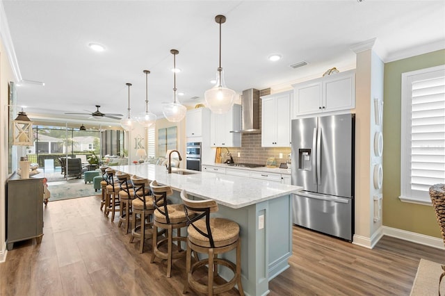 249 Kellet Way, Saint Johns, FL 32259 - kitchen featuring appliances with stainless steel finishes, crown molding, wood finished floors, a large island, and a ceiling fan